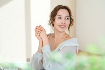 Fototapeta premium Japanese woman applying hand cream to her hands (skincare)