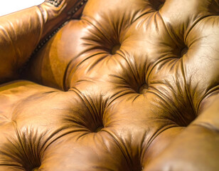 Fototapeta premium Close-up of richly textured, tufted, brown leather upholstery