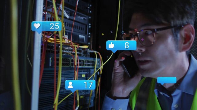 Male IT technician holding smartphone, fixing network rack while animated notifications floating