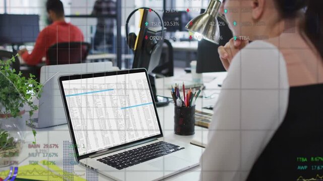 Woman selecting blue row while analyzing spreadsheet, financial charts overlaying screen for trends