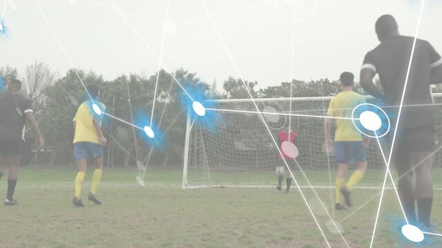 Dribbling tall black-kit man shielding ball into box on pitch, blue overlay, red keeper, copy space
