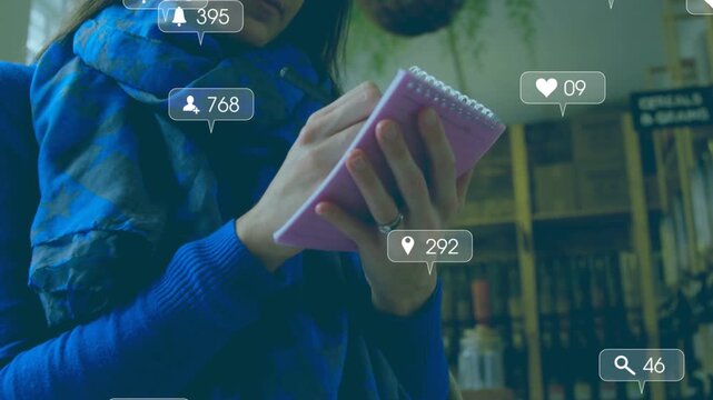Woman holding pink pad tapping pen starting social icons growing around pad showing engagement rise