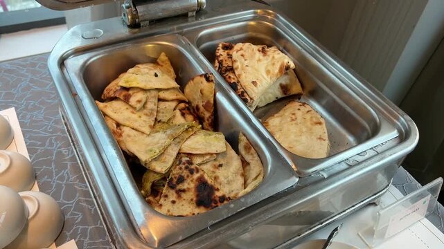 A gourmet serving of hot, buttered Tandoori Roti; a quintessential North Indian staple served as a side dish at a grand wedding event in Kolkata.