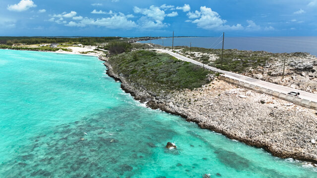 Aerial view of the Glass Window Bridge on a narrow strip of land separating turquoise and deep blue waters in North Eleuthera, North Eleuthera, The Bahamas.