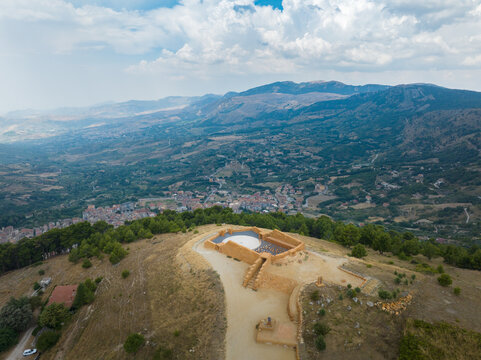 Aerial view of Teatro di Andromeda on a hilltop overlooking the valley and mountains under a cloudy sky in Santo Stefano Quisquina, Sicilia, Italy.