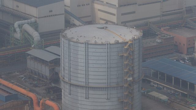 Aerial view of a large cylindrical gas storage tank and industrial factory infrastructure in Lishui Village, Taichung City, Taiwan.