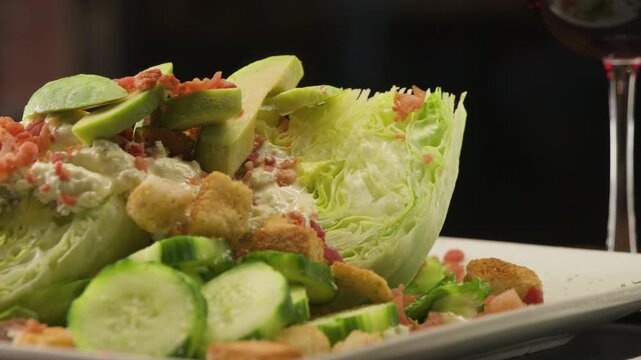 close up of a salad with bacon bits and avocado