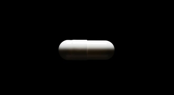 Isolated white capsule, capsule shape, contrasted against stark black background