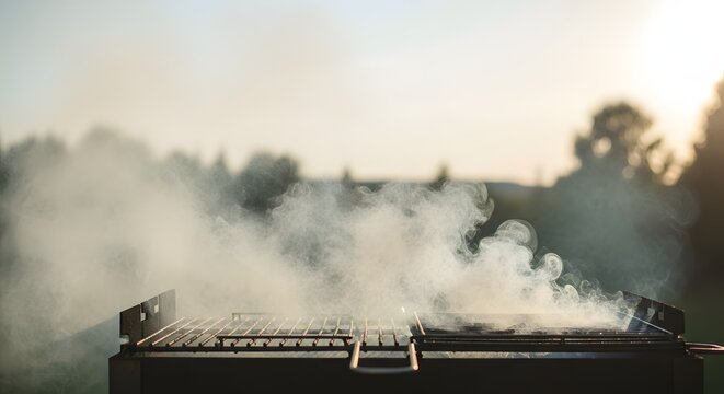 Outdoor barbecue with rising smoke a summertime gathering and cooking scene