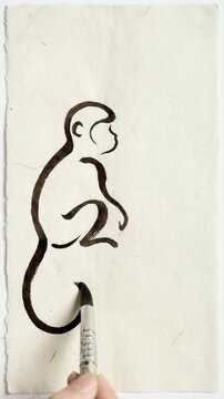A monkey is sitting on a white paper