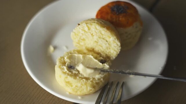 Close up spread butter on a scone