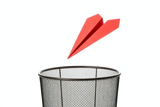 paper plane flying into mesh trash bin. Failed plan
