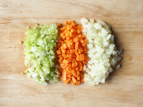Top view piles of diced onion, carrot and celery