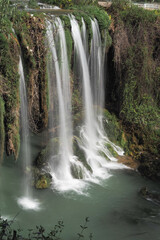 Obraz premium Waterfall flows in a forest during daytime at duden waterfall in antalya