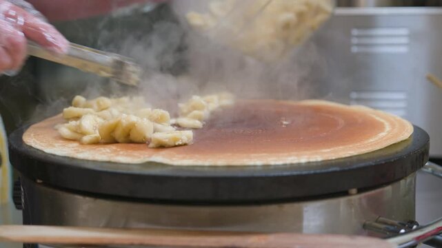 Filling being put onto a crepe