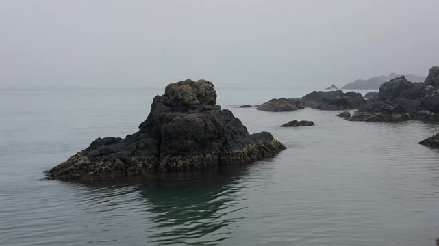 Serene Japanese Coastal Scene With Black Rocks Calm Sea Light Fog and Minimalist Beauty
