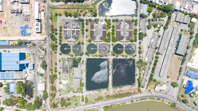 Aerial view of Muang Phuket Municipal Water Quality Development with circular clarifiers and aeration tanks surrounded by lush trees Amphoe Mueang Phuket, Chang Wat Phuket, Thailand.