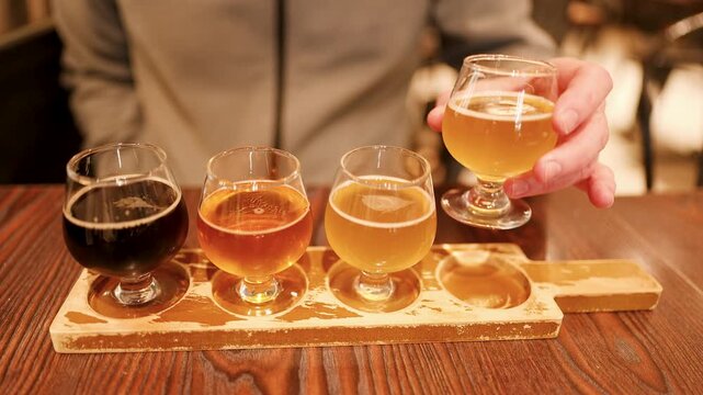 Man Lifting Glass From Craft Beer Tasting Flight in Kanazawa Japan