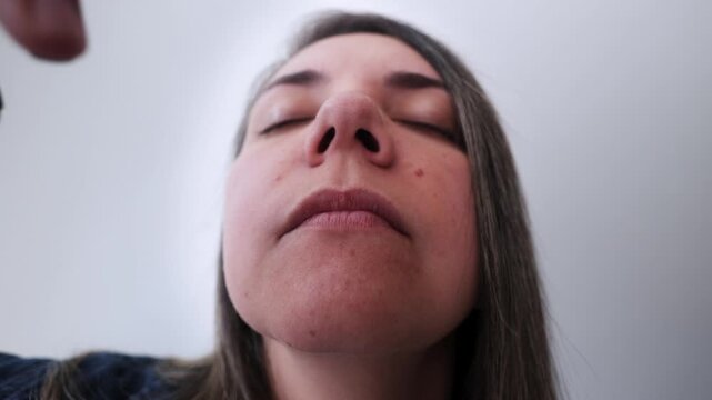 Latina woman using nasal strip for better sleep and breathing - Biohacking and wellness concept