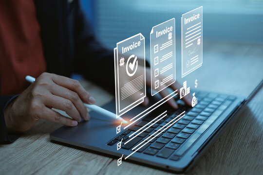 Businessman holding pen pointing at laptop with AI invoice automation interface digital billing management, smart accounting workflow e-invoice processing fintech payment system and paperless finance