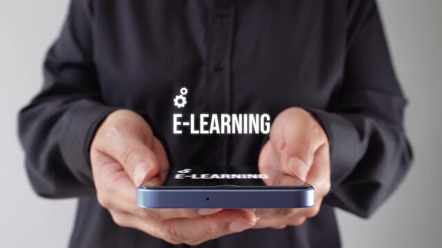 A person holds a phone with bright e-learning icons, displaying clear and modern learning concepts. The user is showcasing technology for the education of the future.