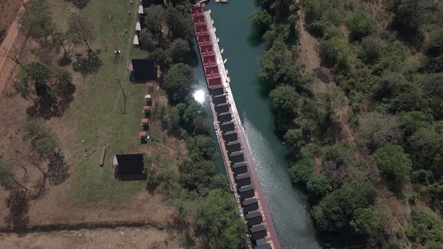 Aerial shot tilting up to reveal the stunning landscape surrounding Tha Falang along the Thakhek Loop.