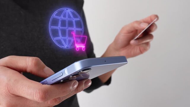 A person holds a phone and gestures with a card. A neon globe and a shopping cart float by. The scene suggests online shopping or global e-commerce.