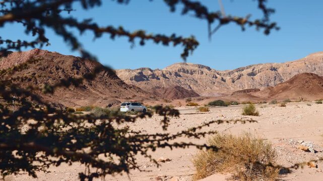 A car drives along a road through Timna National Park in Israel. Road trip. Weekend adventure.