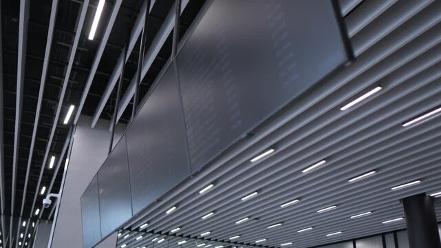 Modern airport ceiling with metallic panels and linear lights