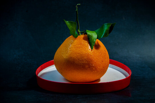 Fresh Ripe Papi Mandarins on Dark Textured Background
