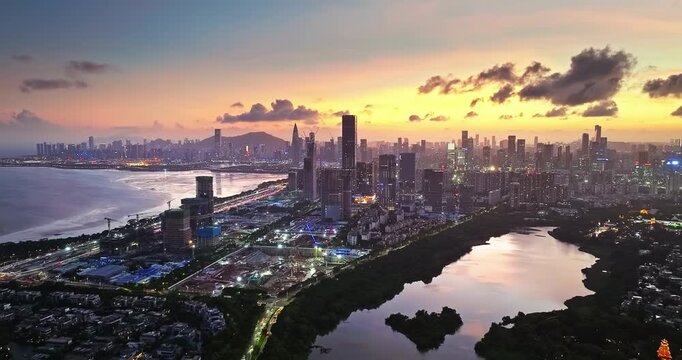 Panoramic aerial view of the modern illuminated cityscape and bay area at dusk, Shenzhen, China