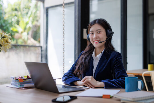 Young asian woman providing customer support smiling