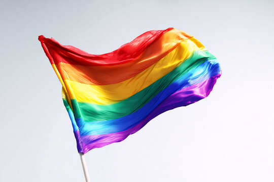 Rainbow flag waving with vibrant colors symbol of pride and diversity isolated on white background
