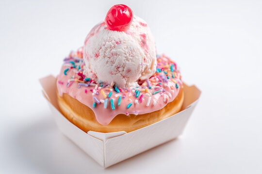 Ice cream scoop with sprinkles and cherry on waffle dessert treat isolated on white background
