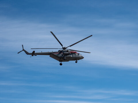Mi-8 helicopter flying against blue sky aviation transport aerial vehicle clear weather and open air flight.