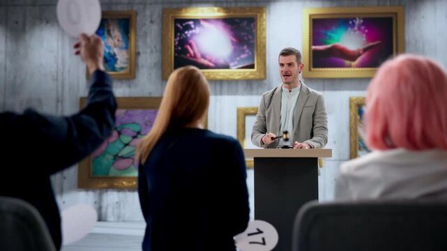 Auctioneer Leads Artwork Auction, Calls Bids