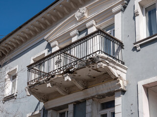 Fototapeta premium Old vintage balcony in need of restoration weathered architectural detail on building facade.