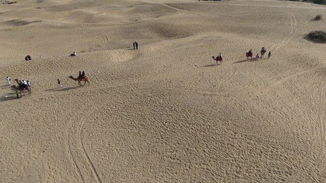 Aerial View of Tourists Enjoying Camel Ride in Jaisalmer Thar Desert Rajasthan India