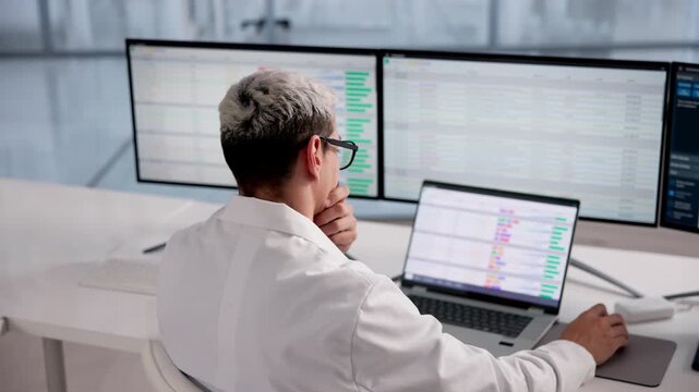 Exhausted Doctor Struggling With Computer