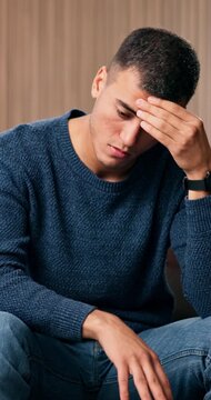 Mental health, thinking or man in home with headache, anxiety trigger or memory of past trauma. Pressure, flashback or person in lounge with migraine, overthinking or fatigue in emotional thoughts.