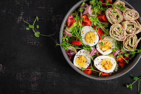 Meal prep keto diet with high protein food eggs and tuna wraps. Top view