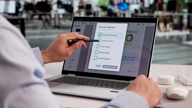 Hispanic Man Using Cloud-Based Software To Review And Approve Documents