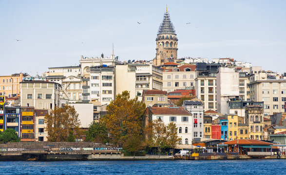 Galata Tower landmark and Karak&ouml;y district skyline over the Golden Horn, Istanbul, Turkey. Urban cityscape with traditional and modern architecture under clear sky in Beyoğlu.