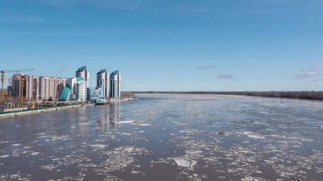 April 09 2026 Barnaul Russia timelapse of ice drift on river floating ice floes blue sky with white clouds spring thaw.