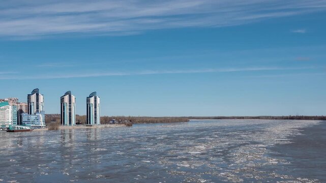 April 09 2026 Barnaul Russia timelapse of ice drift on river floating ice floes blue sky with white clouds spring thaw.