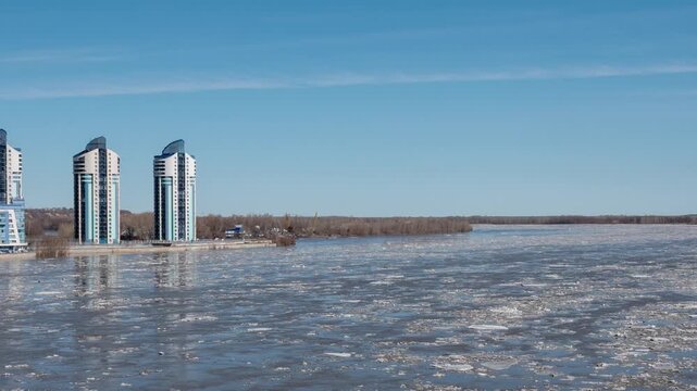 April 09 2026 Barnaul Russia timelapse of ice drift on river floating ice floes blue sky with white clouds spring thaw.
