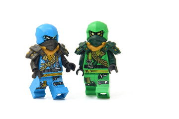 Naklejka premium Editorial illustrative image of two lego ninjago minifigures green ninja Lloyd and blue Jay isolated on white.