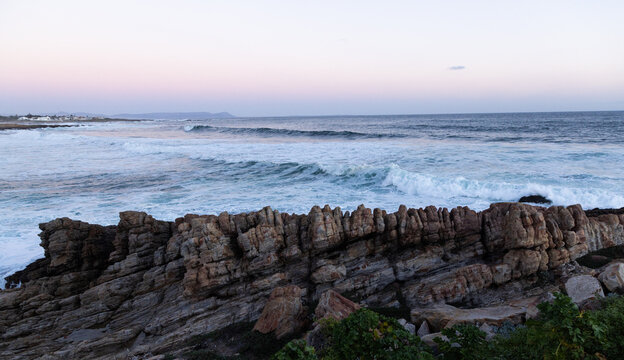 rocky coastline of Onrus, South Africa at dusk