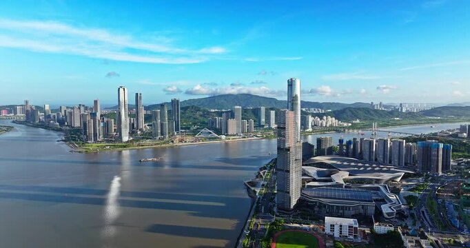 Drone view of modern financial district skyscrapers and city skyline by the river, Zhuhai, China.