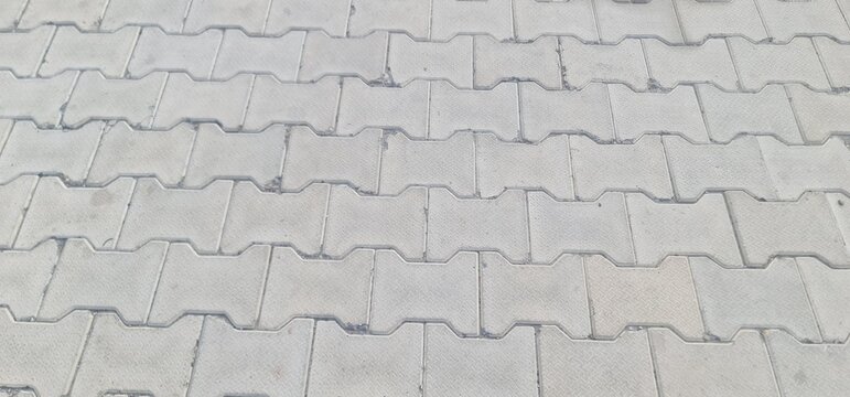 Seamless Pattern of Grey Interlocking Concrete Paver Blocks for Outdoor Pavement